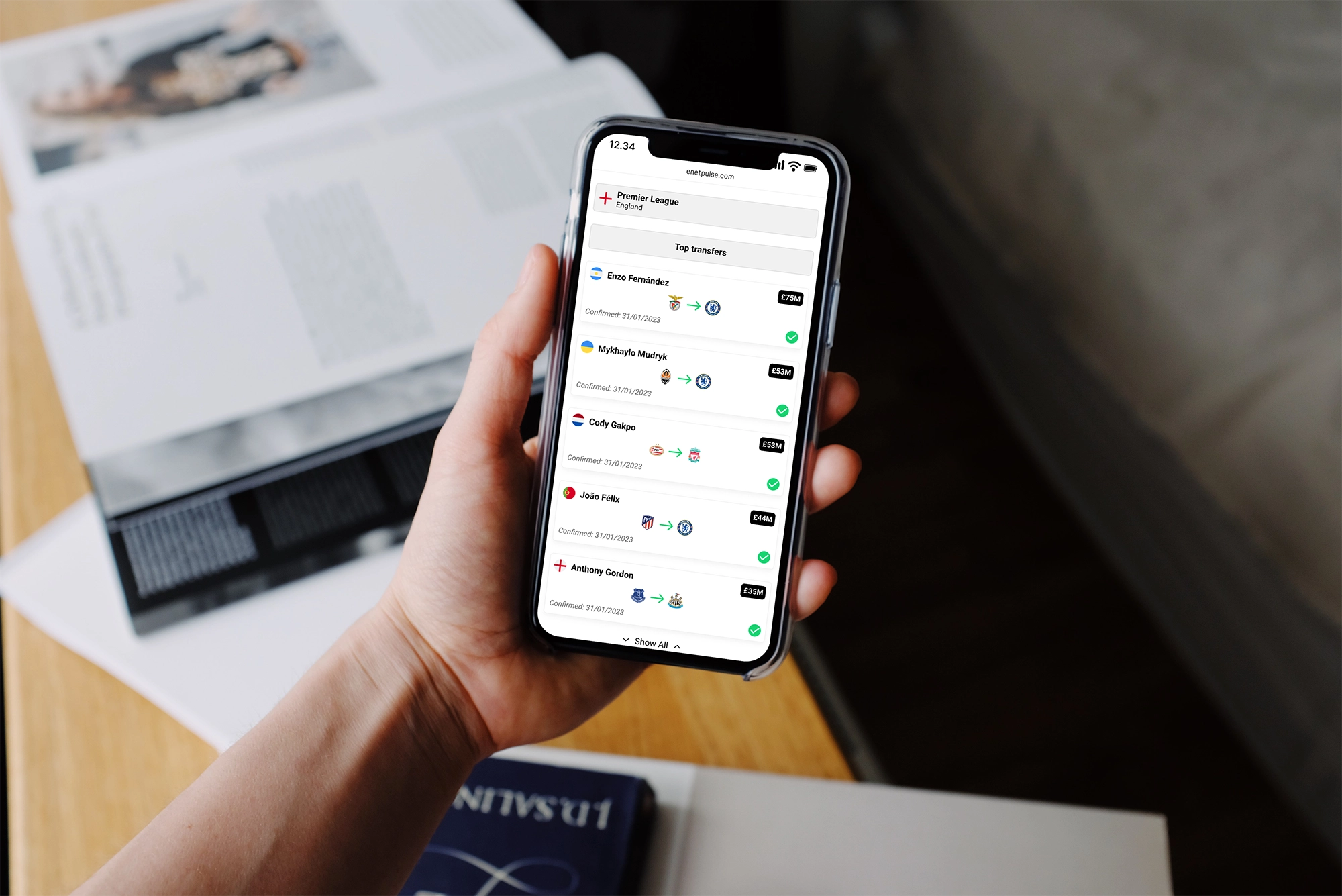 Person holding an iphone showing Enetpulse transfer center feature